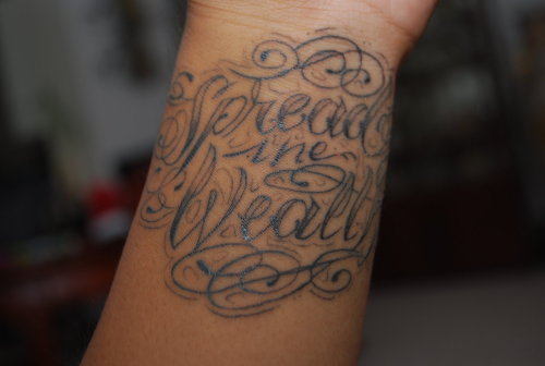 My first tattoo of the slogan I live by, “Spread the Wealth.