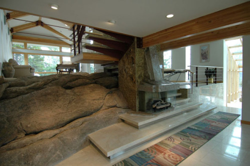 Using what was considered by most to be un-buildable granite outcropping, Gibson architect took advantage of the variety and cascading effect of the natural granite to create a house which evolved into seven levels revolving around the main central fireplace built into the largest granite boulder.
