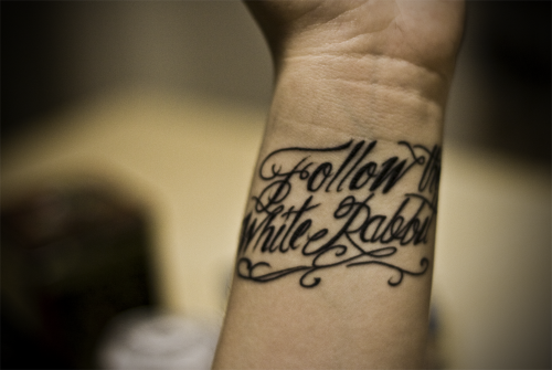 It says “follow the white rabbit”, because if Alice didn't follow the white 