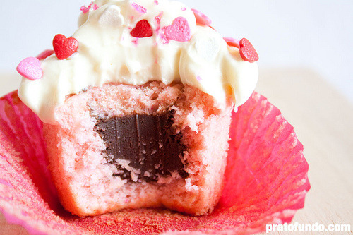 gastrogirl:

vanilla rose cupcake with chocolate truffle center.
