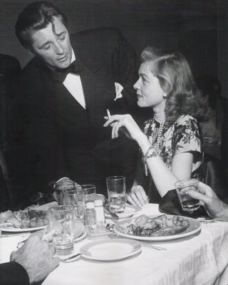 Robert Mitchum greets Lauren Bacall at a party Don 8217t you want
