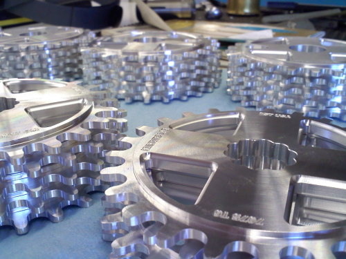Stacks of 25T spline and bolt drive sprockets fresh off the CNC mill.