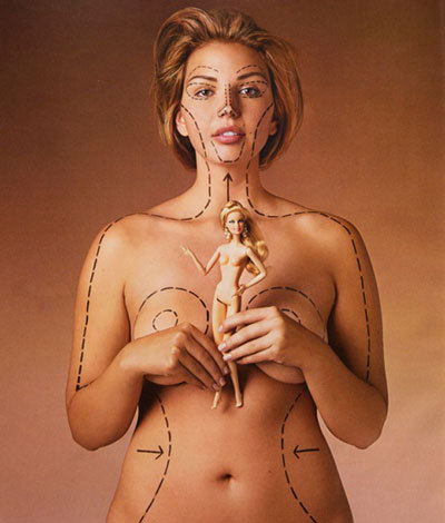 Barbie vs reality: via Healthy Is The New Skinny:
“This is Katie Halchishick, one of the founders of the blog Healthy Is The New Skinny. She was photographed for the November issue of O magazine covered in the dotted lines that would be made by a plastic surgeon prior to cosmetic surgery. She’s clutching a Barbie doll and the lines on her nude flesh — the first time O has featured a nude model — indicate what she would have to have cut away in order to have Barbie’s figure.”