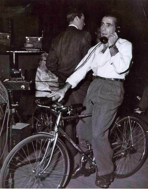 Humphrey Bogart rides a bike. And takes a call.