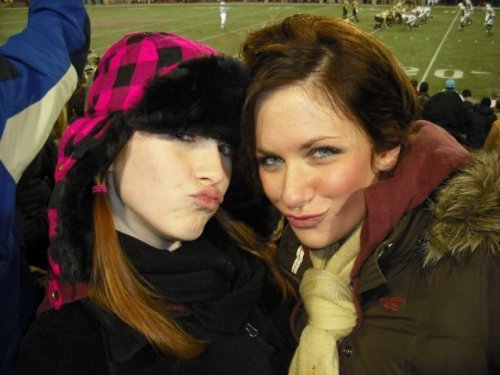 we like how the football field is behind them, like they only came to the game so they could take duckface pics with football in the background or something.